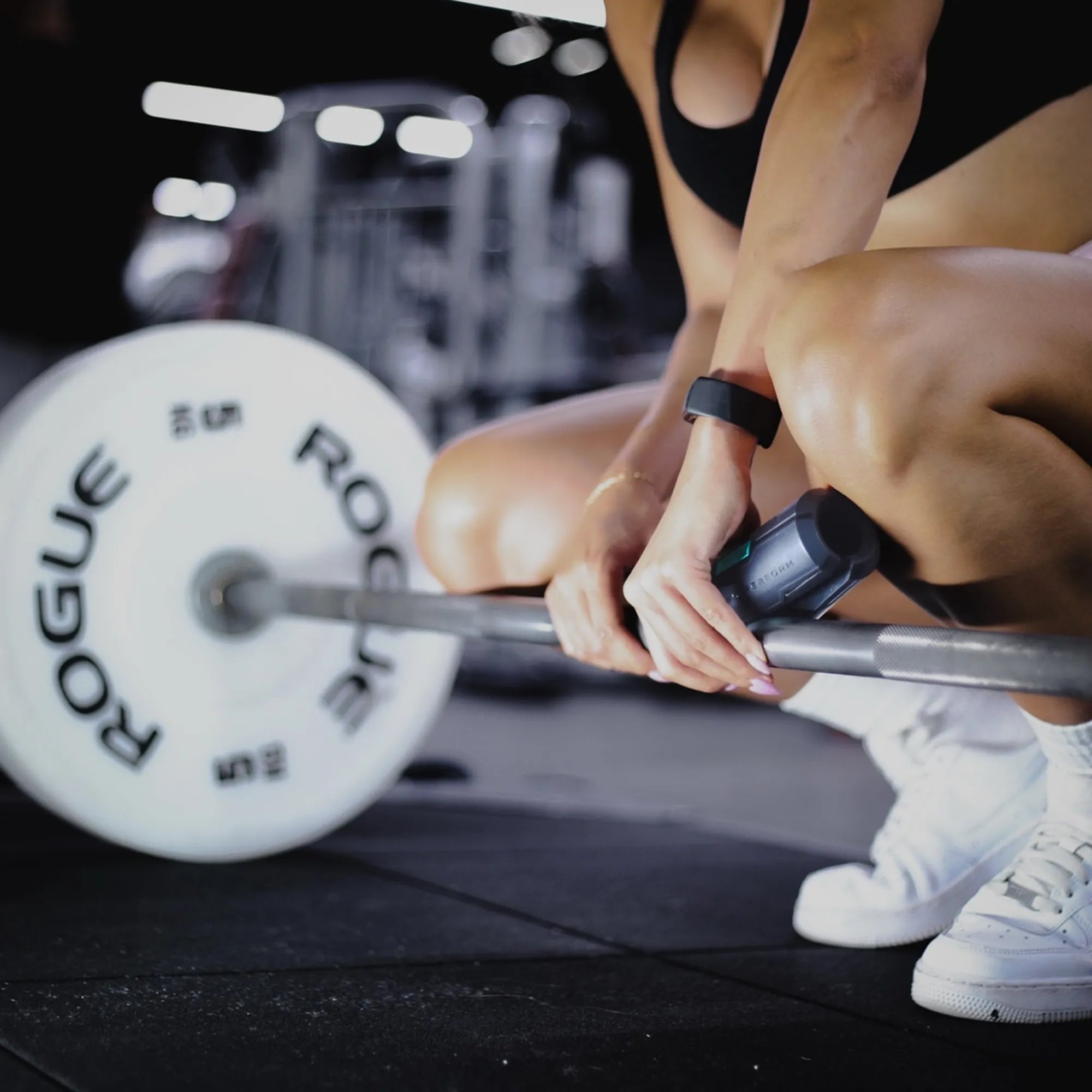 Athlete loading a barbell with the Sniperform LevelUp grip in place